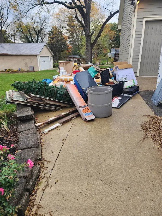 Dumpster being loaded with debris for Residential Dumpster Rental in Williamstown